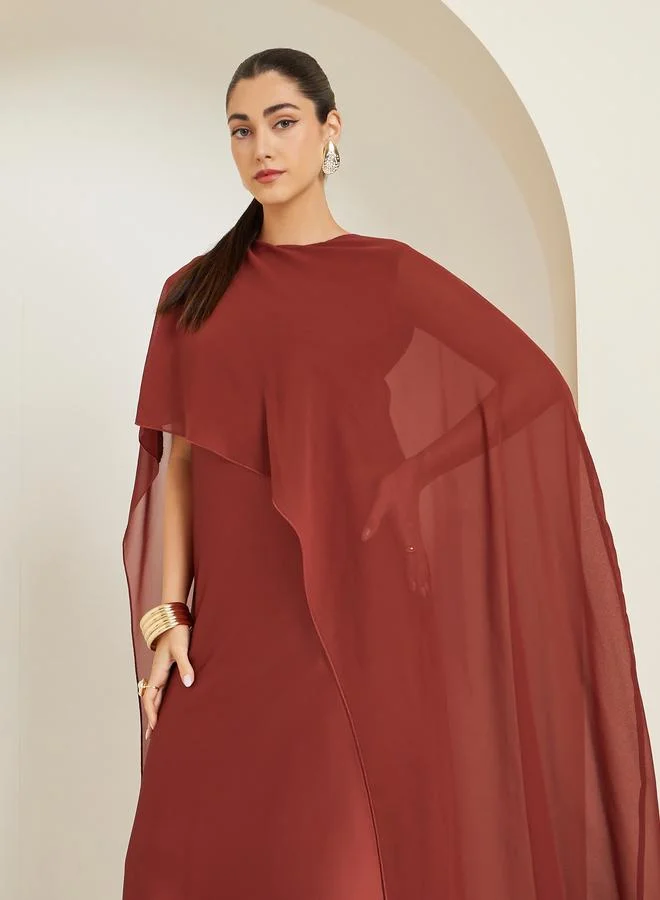 ستايلي فستان طويل بلون صدئي وأكمام كاب وقصة واسعة